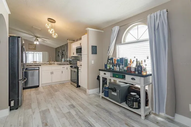 a kitchen with a stove a sink and a refrigerator
