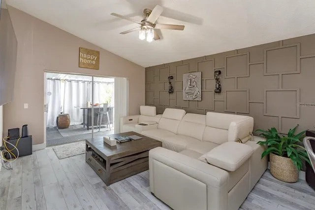 a living room with furniture potted plant and window
