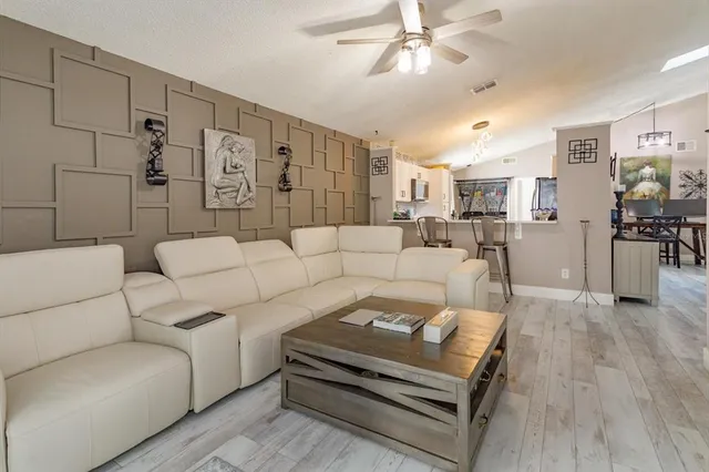 a living room with furniture and a chandelier