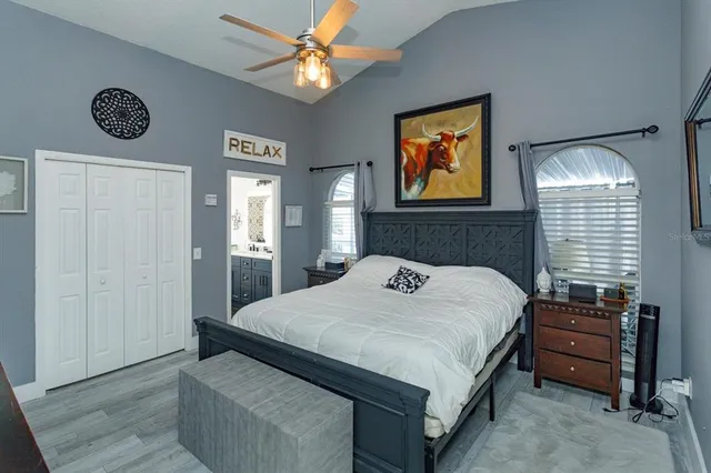 a bedroom with a bed and a chandelier