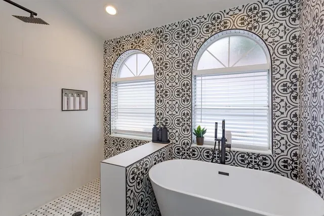 a bathroom with a sink a mirror and a bathtub