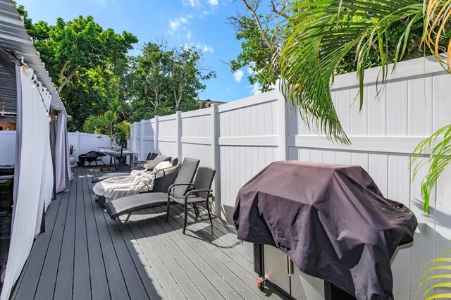 a view of backyard with outdoor seating and wooden floor