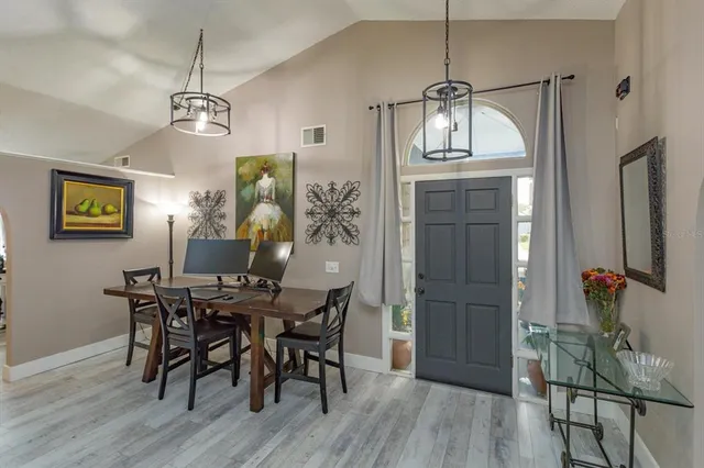 a view of a dining room with furniture wooden floor and chandelier