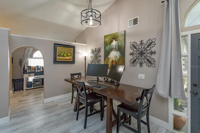 a view of a dining room with furniture and wooden floor