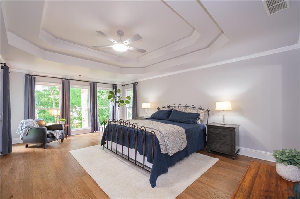 4330 Farmbrook Lane Cumming, GA 30041 - Photo 20 of 46 a spacious bedroom with a large bed and windows