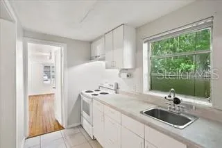 a kitchen with sink a stove and refrigerator