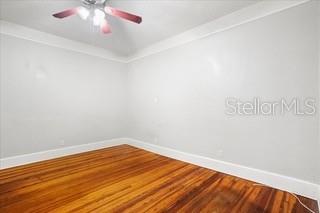 726 West Central Avenue Winter Haven, FL 33880 - Photo 7 of 10 an empty room with wooden floor and windows