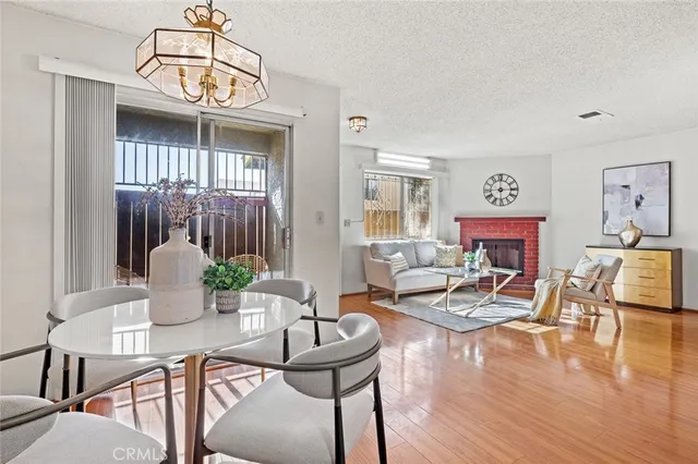 a living room with fireplace furniture and a wooden floor