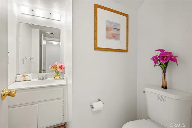 a bathroom with a sink mirror and vanity