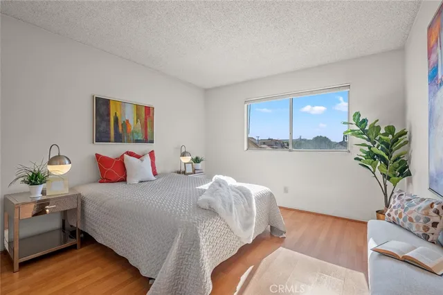 a bedroom with bed and a potted plant
