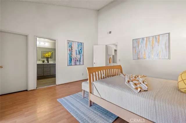 a bedroom with a bed and wooden floor