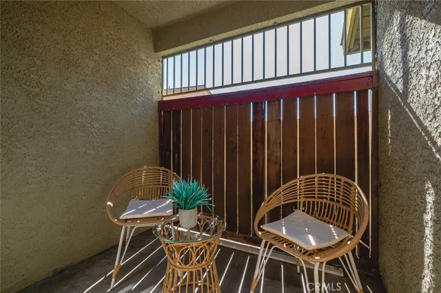 a view of a balcony with chair and table