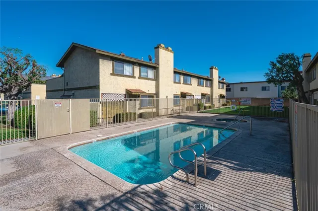 a swimming pool with outdoor seating and yard