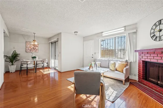 a living room with furniture a fireplace and a table