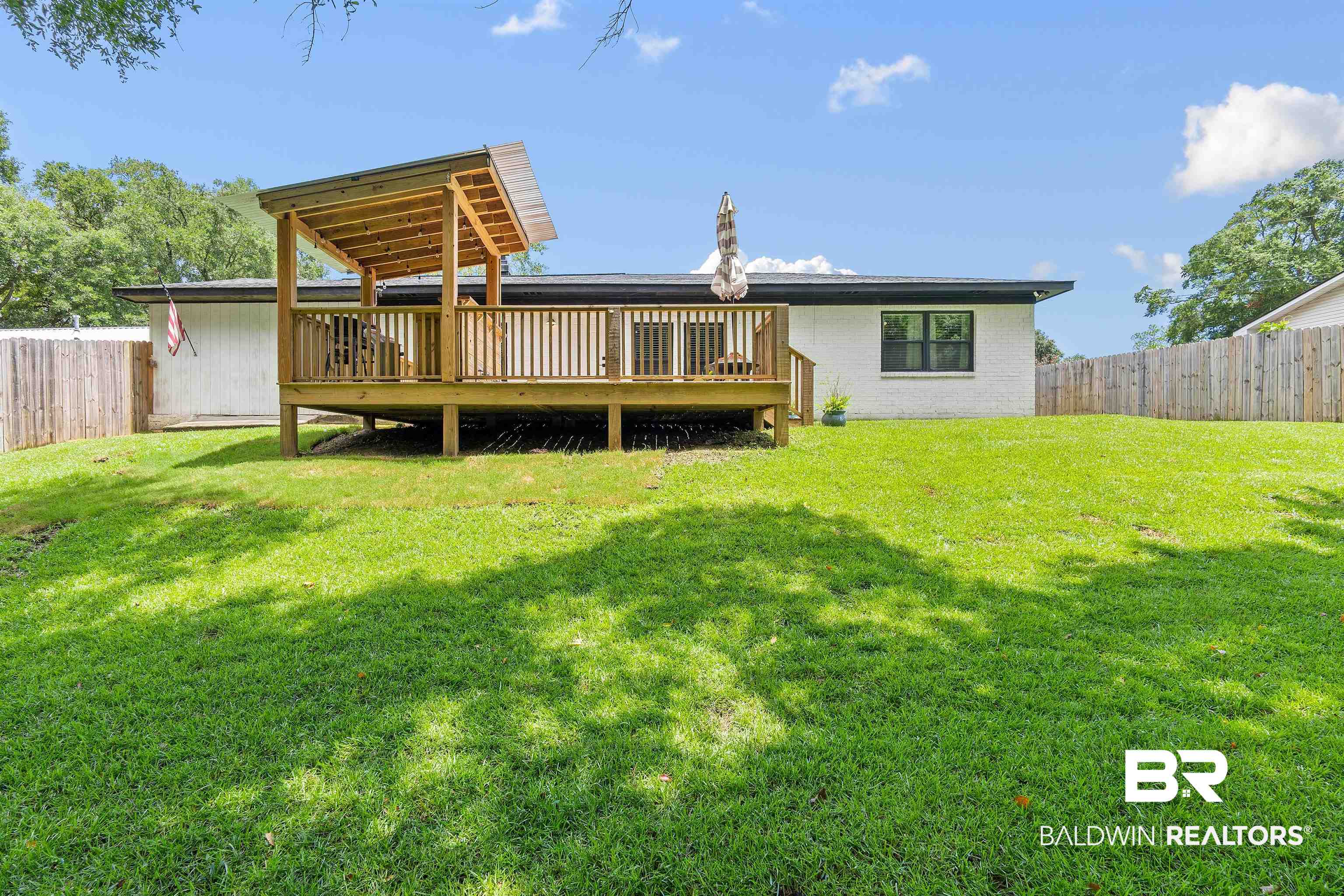 4682 Opal Drive Mobile, AL 36619 - Photo 27 of 27 Rear view of property featuring a wooden deck and a yard