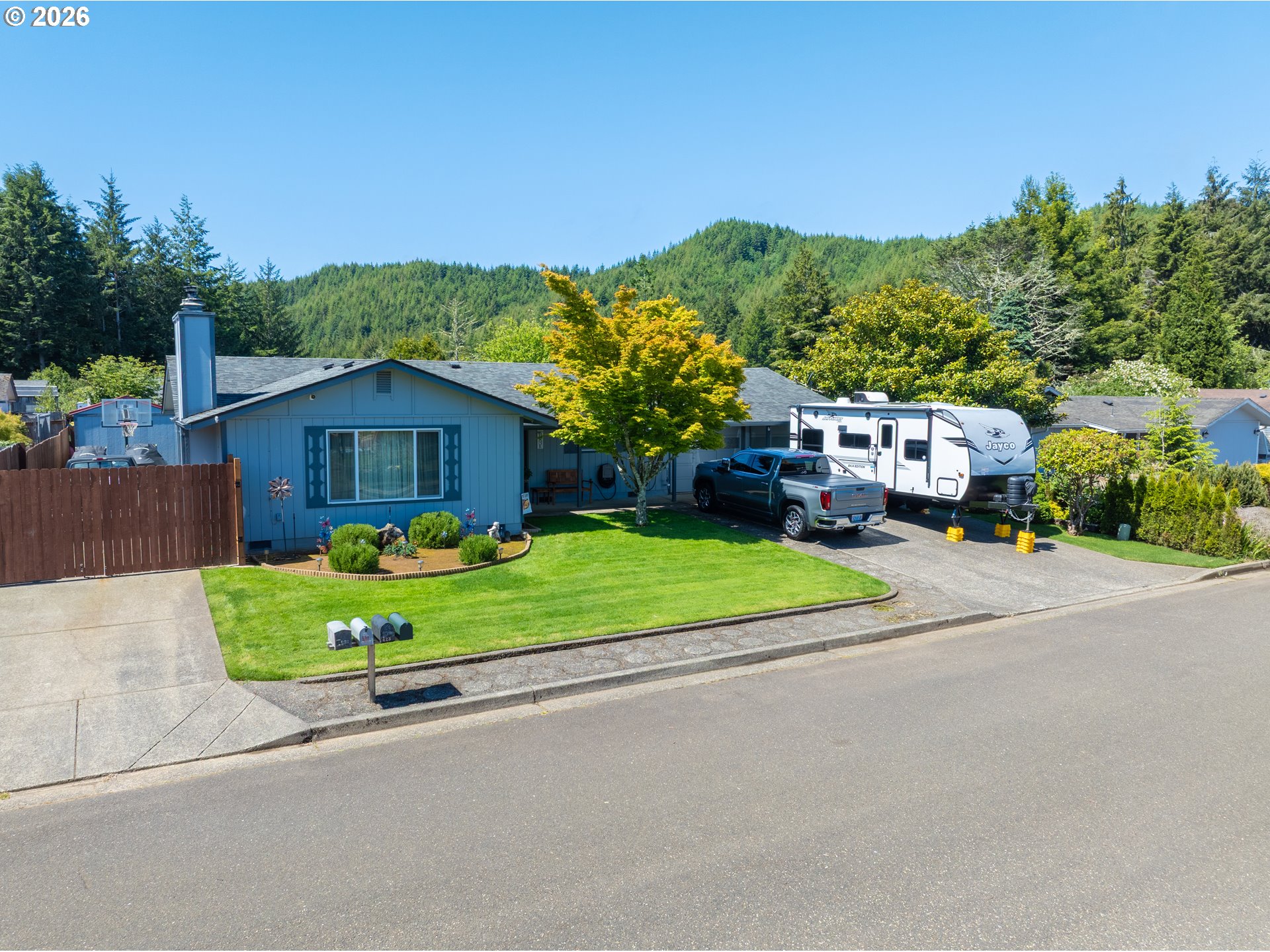 412 Camellia Court Reedsport, OR 97467 - Photo 48 of 48 a front view of a house with a yard and garage