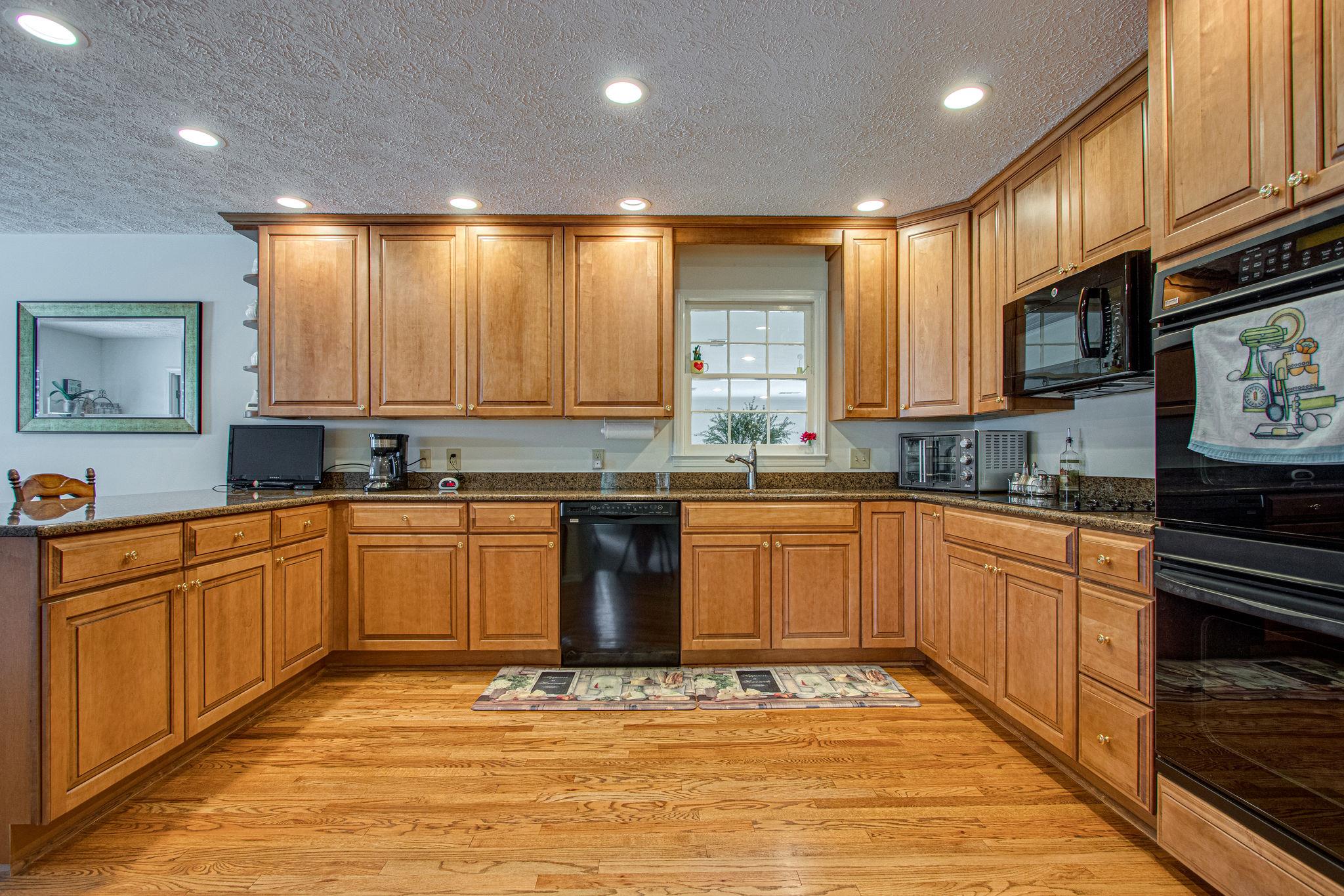 5214 Rustic Way Old Hickory, TN 37138 - Photo 6 of 30 The large kitchen features granite counter tops and maple cabinets.