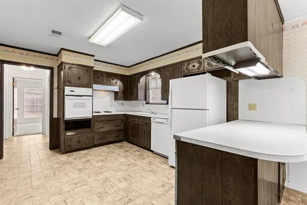 a kitchen with stainless steel appliances granite countertop a refrigerator sink and stove