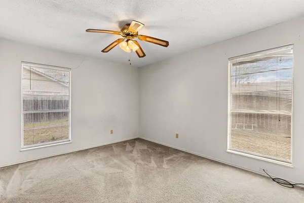 a view of hallway with chandelier fan