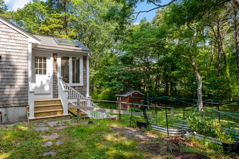 a front view of a house with a yard table and chairs