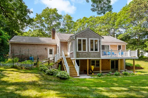 a view of a house with a yard porch and sitting area