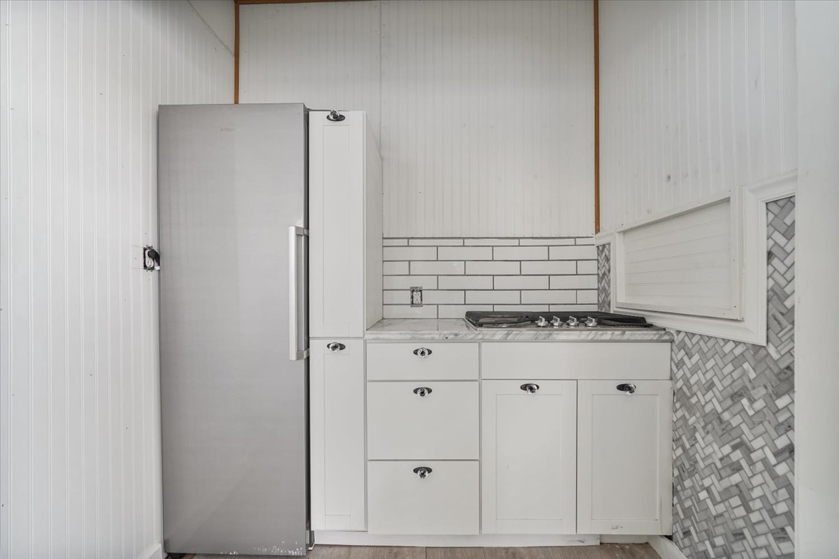 104 Magoun Street Bloomington, IL 61701 - Photo 17 of 28 a kitchen with stainless steel appliances granite countertop a sink and a refrigerator