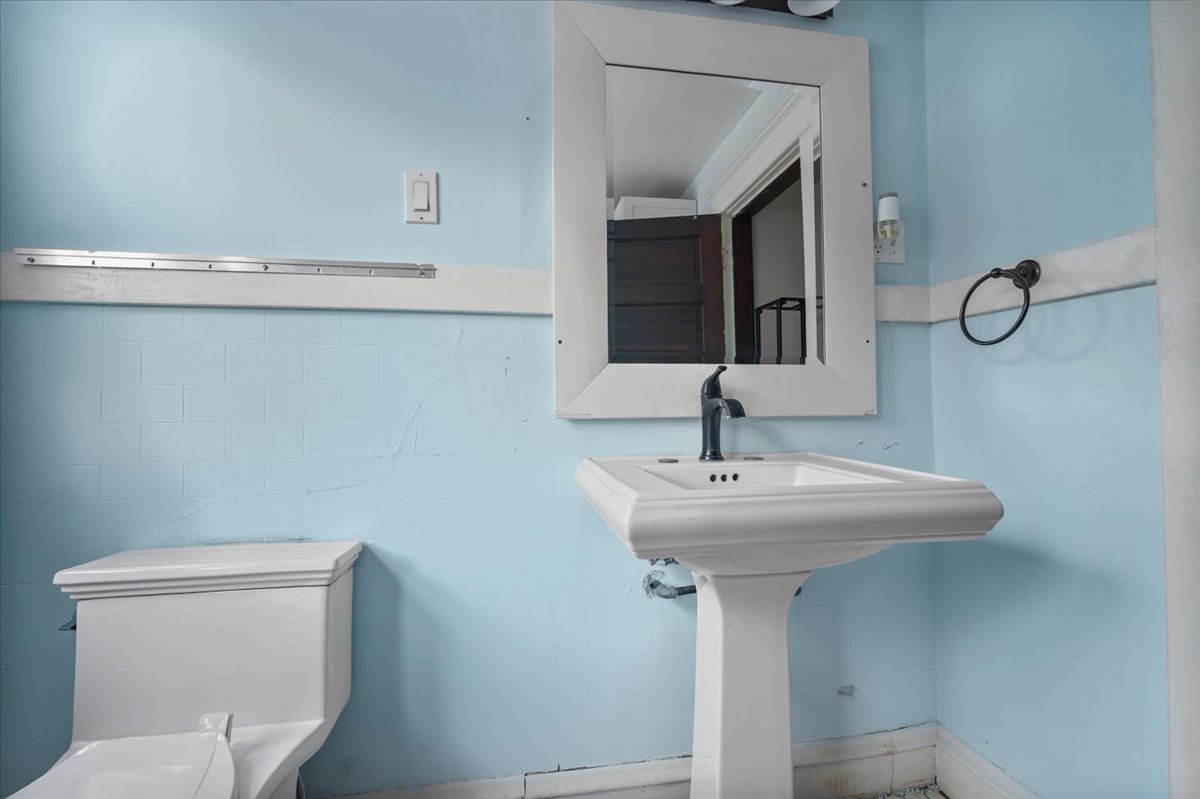 104 Magoun Street Bloomington, IL 61701 - Photo 19 of 28 a bathroom with a sink a toilet and mirror