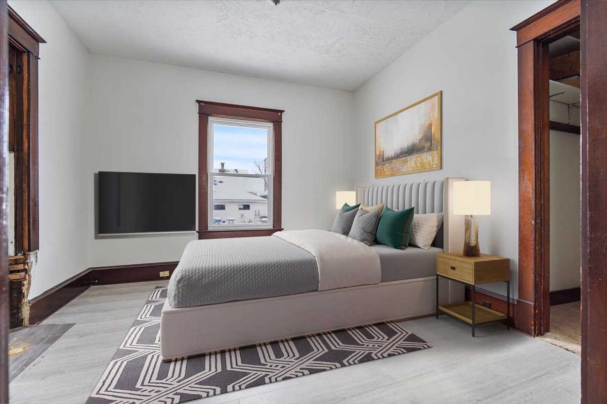 104 Magoun Street Bloomington, IL 61701 - Photo 4 of 28 a bedroom with a bed and a television