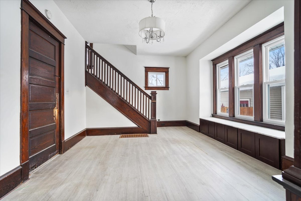 104 Magoun Street Bloomington, IL 61701 - Photo 9 of 28 a view of an entryway with wooden floor and windows