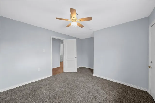 a view of an empty room with a ceiling fan