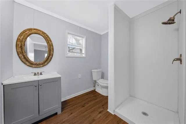 a bathroom with a toilet a sink and a mirror