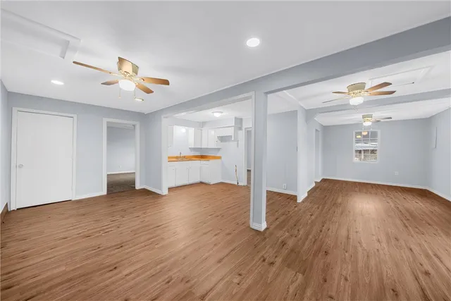 a view of an empty room and wooden floor