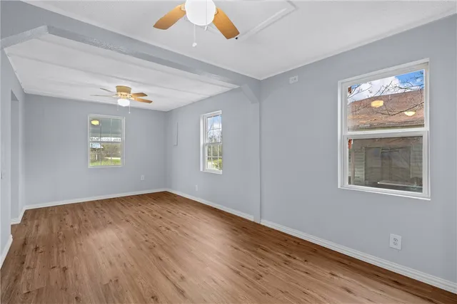 wooden floor in an empty room with a window