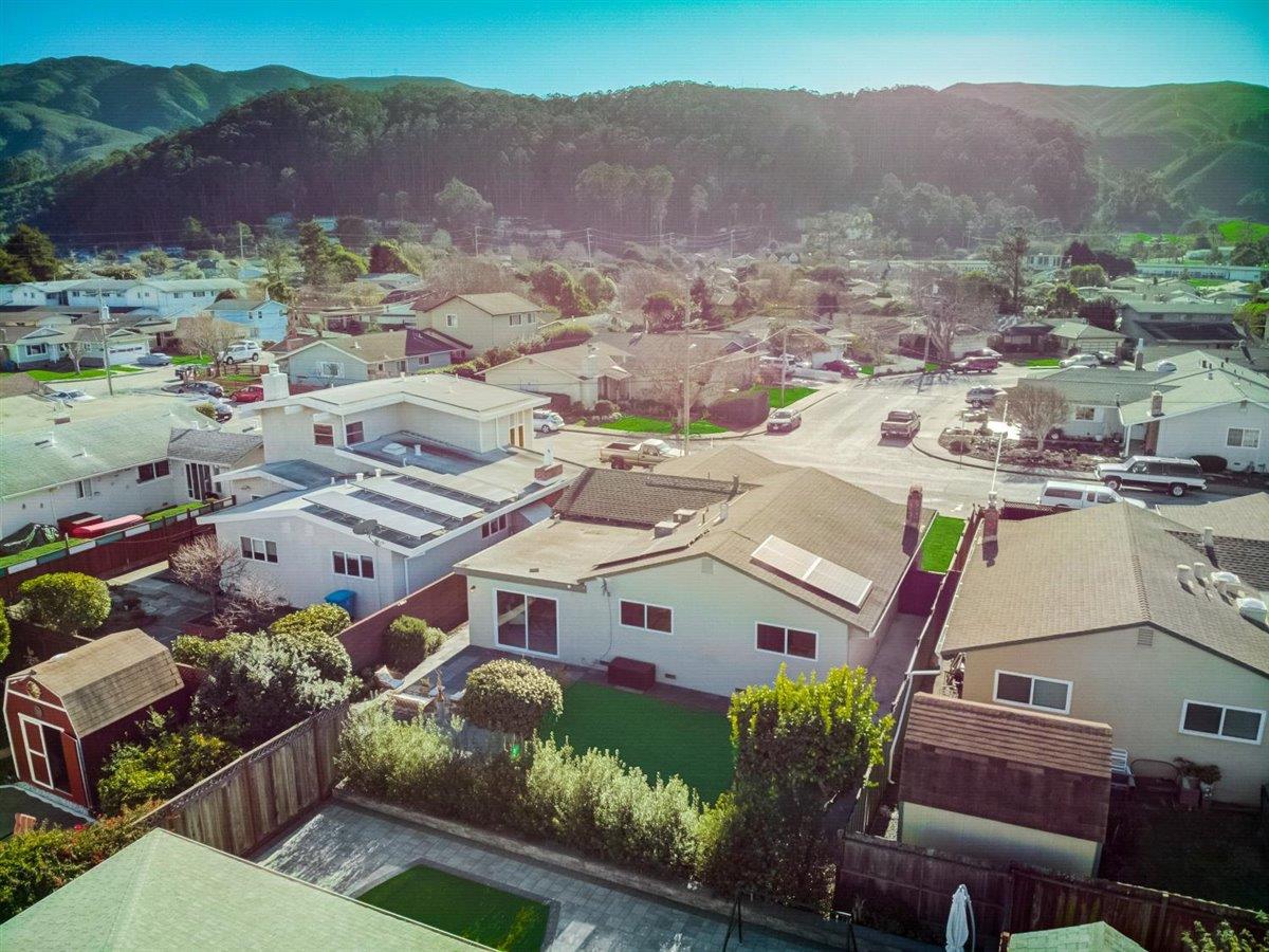 855 Standish Road Pacifica, CA 94044 - Photo 64 of 77 an aerial view of a house with a mountain in the background
