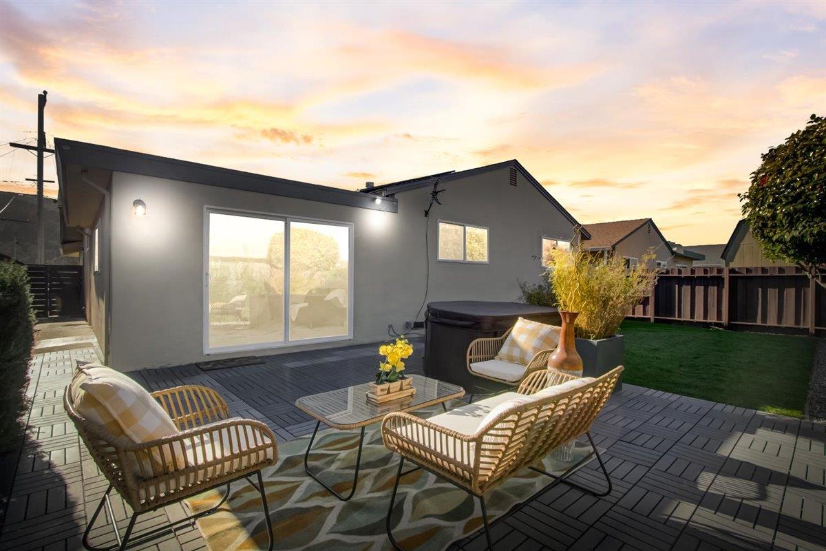 855 Standish Road Pacifica, CA 94044 - Photo 71 of 77 a view of a patio with couches and a table and chairs with wooden floor and fence