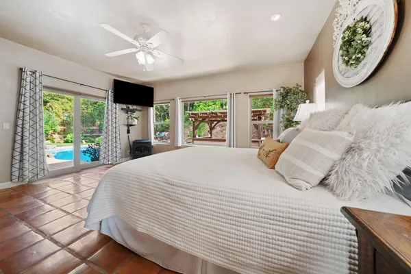 a spacious bathroom with a tub sink and mirror