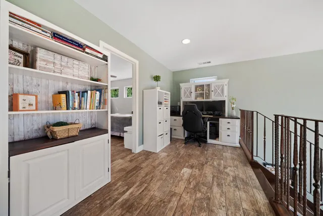 a bathroom with a granite countertop double vanity sink and a mirror