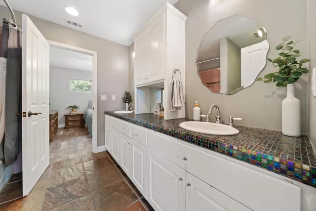 a bedroom with a bed and a painting on the wall