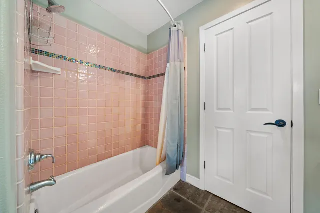 a bedroom with a bed and a flat tv screen