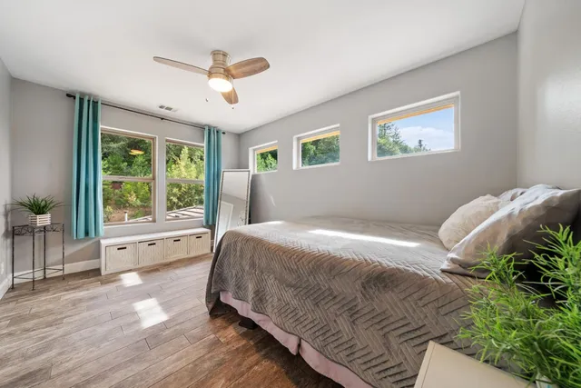 a hallway with a couch and dresser with wooden floor