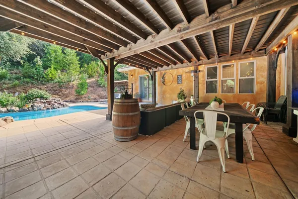 a front view of a house with a yard table and chairs
