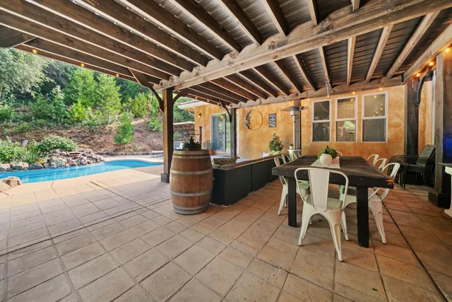 a front view of a house with a yard table and chairs