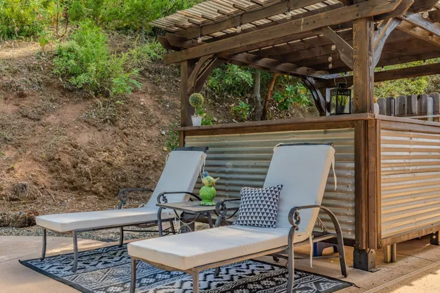 a view of a patio with table and chairs