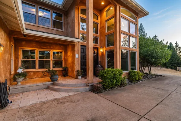 an aerial view of a house with yard swimming pool and outdoor seating