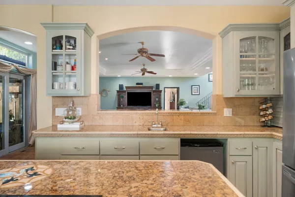 a kitchen with stainless steel appliances granite countertop a stove a sink and a refrigerator
