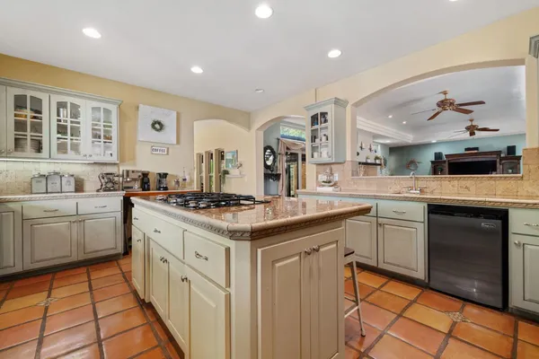 a spacious bathroom with a granite countertop sink and a mirror