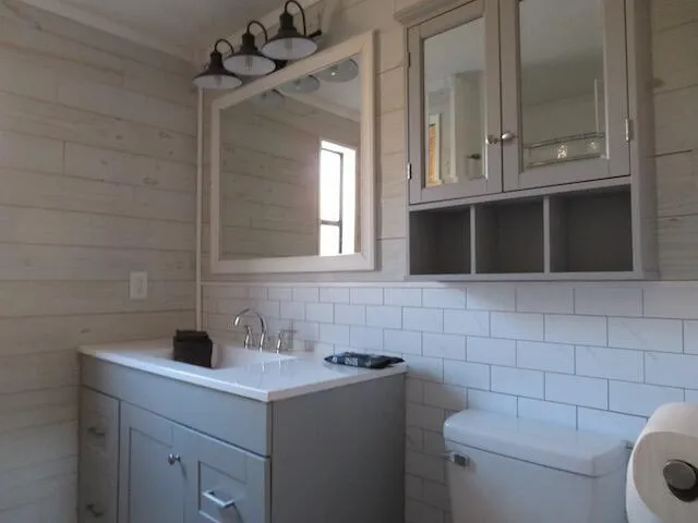 a view of a back yard of the house with a car park