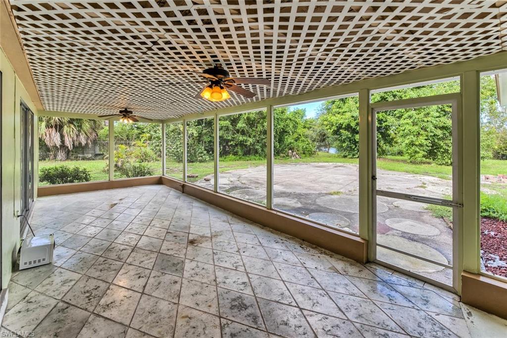 29 Caribbean Road Naples, FL 34108 - Photo 32 of 32 Unfurnished sunroom with ceiling fan
