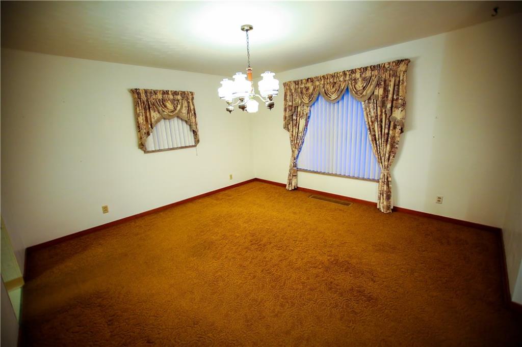 1161 Bonniebrook Road Butler, PA 16002 - Photo 13 of 25 Large Dining Room Leading to living Room and Kitchen with Hard wood floors under carpter