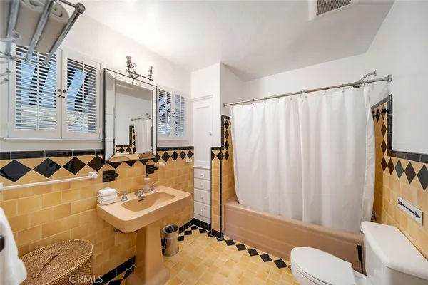 a bathroom with a sink toilet a mirror and shower